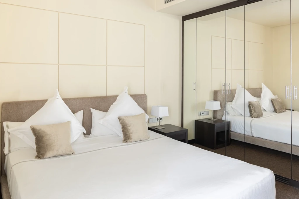 In Economy Double Room the large bed and the spacious chiffonier